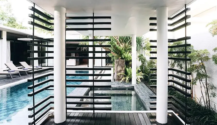Ambergris Villa, Nusa Dua, Bali — contemporary covered poolside gazebo with white columns dark wooden slats shading mini spa pool connected | The Luxury Bali