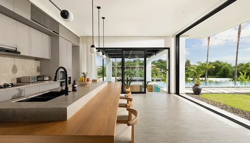 Arita Villa Canggu, Canggu, Bali — spacious villa kitchen with a sleek design and barstools | The Luxury Bali