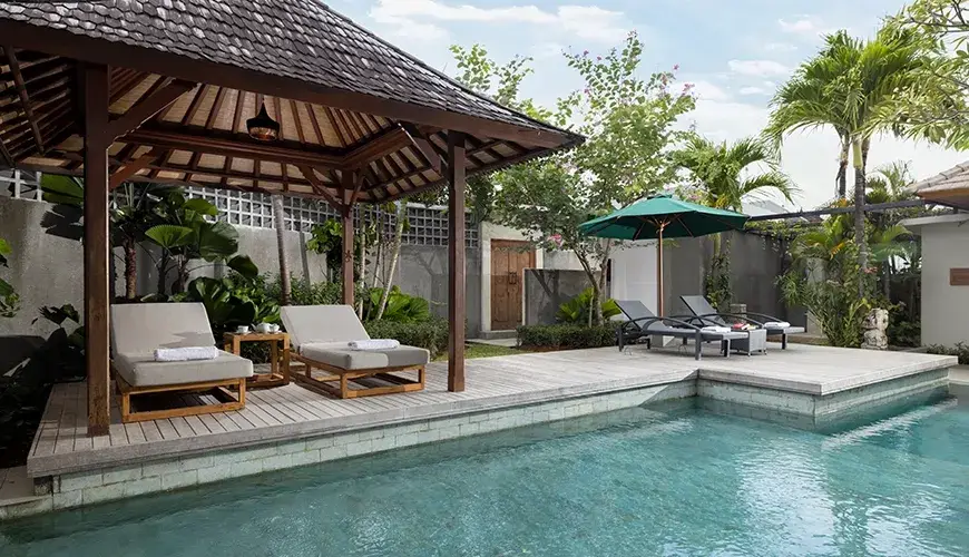 Villa Christie, Seminyak, Bali — beautiful swimming pool area with shaded gazebo and loungers | The Luxury Bali