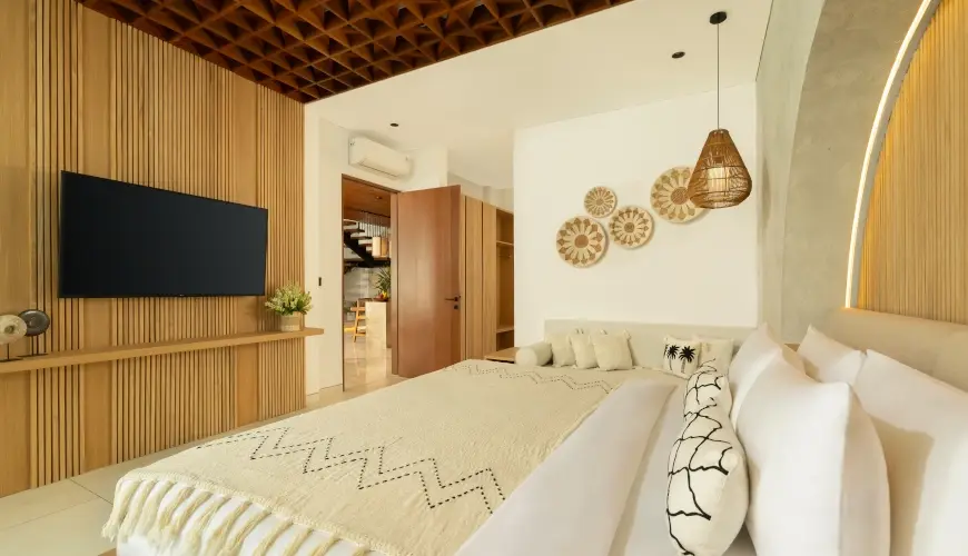 Fenta Villa, Canggu, Bali — warm balinese master bedroom with wooden accents and natural decor | The Luxury Bali