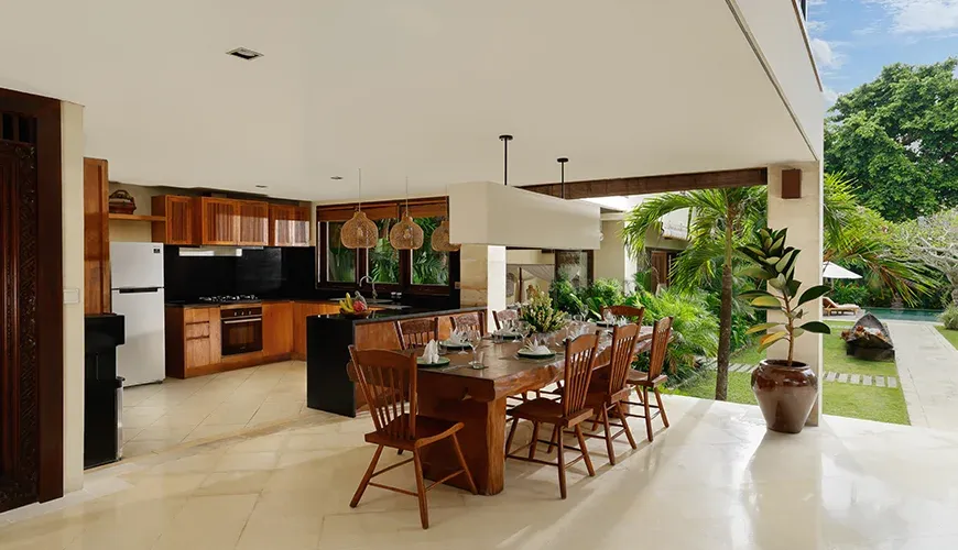 Villa Nelayan, Seminyak, Bali — open kitchen and dining space facing lush garden canggu | The Luxury Bali