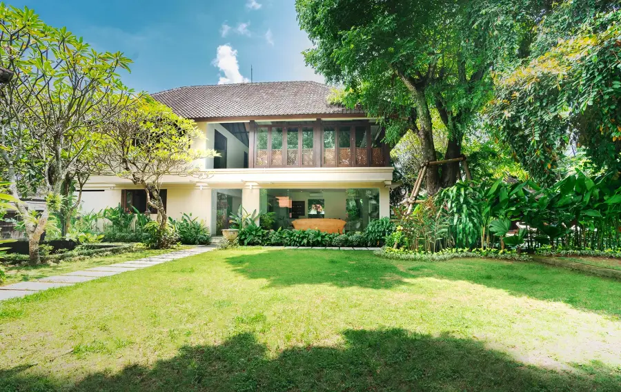 Asraya Villa, a four-bedroom villa in Sanur, Bali: the house behind a lawn and mature trees