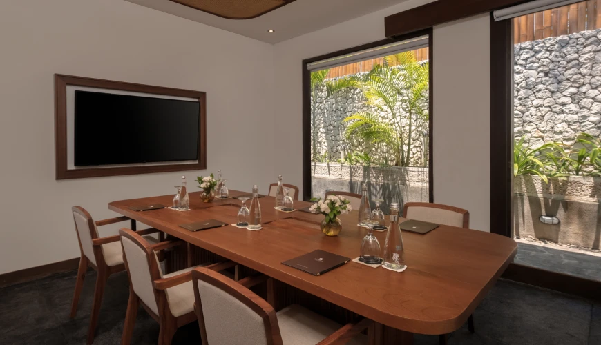 Shanti Residence, Nusa Dua, Bali — professional villa meeting room featuring a wooden conference table and wall mounted television with a garden | The Luxury Bali
