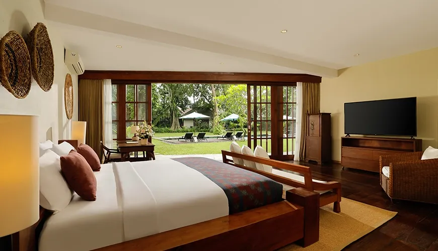 Villa Tirtadari, Kerobokan, Bali — spacious master suite featuring warm lighting and wood details seminyak | The Luxury Bali