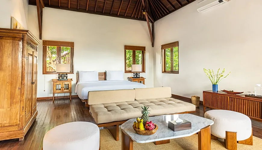 Tropical Svasti Villa, Canggu, Bali — spacious bedroom with high wooden ceiling and traditional decor | The Luxury Bali
