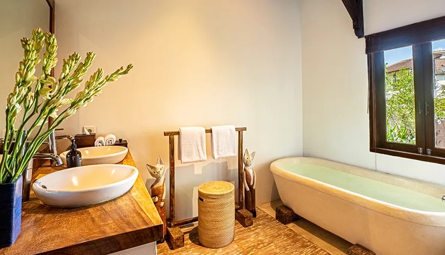 Tropical Svasti Villa, Canggu, Bali — traditional bathroom with free standing tub and wooden vanity | The Luxury Bali