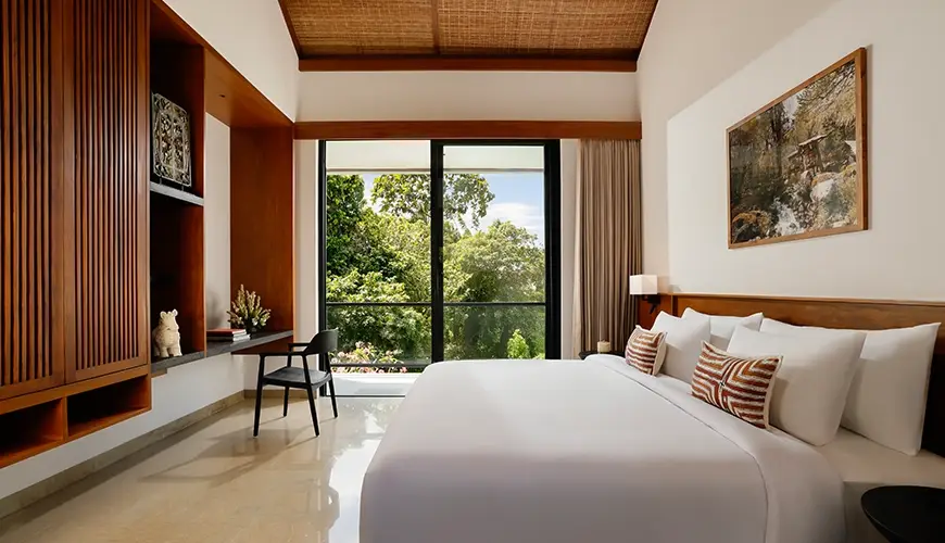 Uma Santai Canggu, Canggu, Bali — inviting villa bedroom with a spacious bed a wooden desk and sliding doors that open | The Luxury Bali