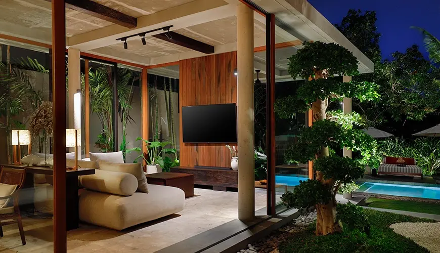 Uma Santai Pererenan, Pererenan, Bali — contemporary open concept villa living room featuring a flat screen television and beautiful pool view patio | The Luxury Bali
