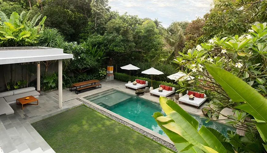 Uma Santai Pererenan, Pererenan, Bali — stunning elevated view of a luxury villa pool surrounded by lush tropical trees and landscaping canggu | The Luxury Bali