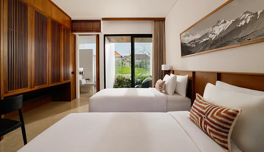 Uma Santai Canggu, Canggu, Bali — spacious twin bedroom in a villa with two comfortable beds and a window that opens up | The Luxury Bali