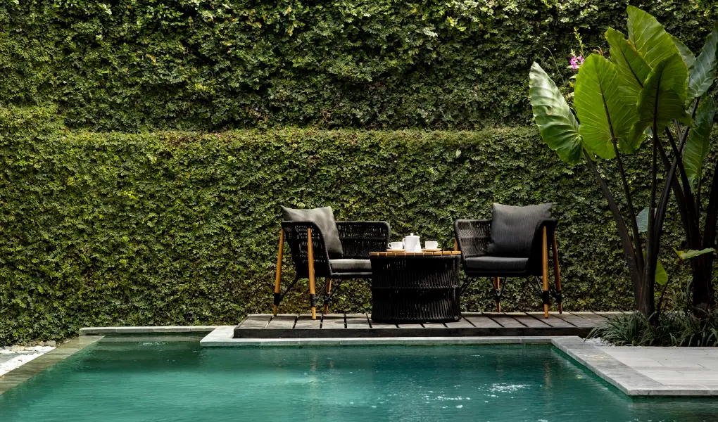 Villa Ambara, Canggu, Bali — cozy outdoor seating area next to a private swimming pool | The Luxury Bali