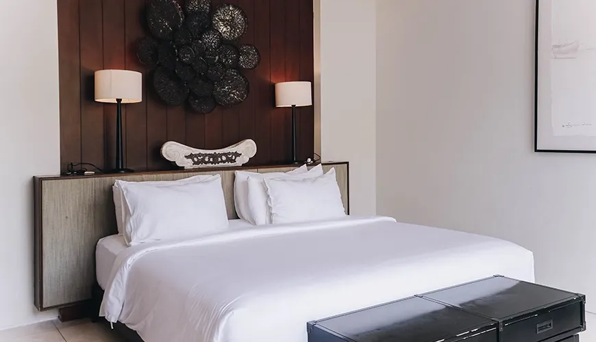 Ambergris Villa, Nusa Dua, Bali — elegant bedroom features a comfortable bed and distinctive dark accent wall canggu | The Luxury Bali