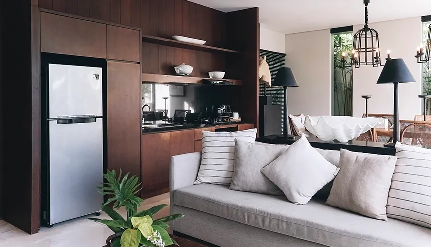 Ambergris Villa, Nusa Dua, Bali — fully equipped kitchen features dark wood cabinets and a bright outdoor view canggu | The Luxury Bali