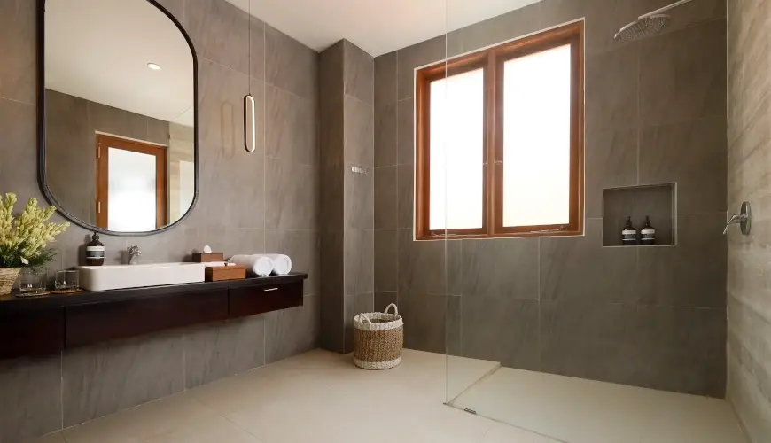Villa Ananya, Seminyak, Bali — contemporary grey tiled bathroom with sleek vanity and walk in shower | The Luxury Bali