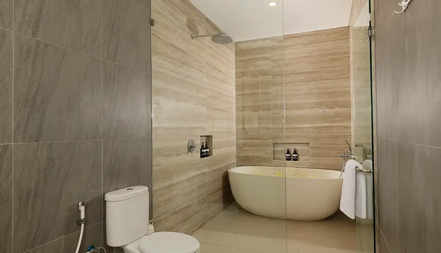 Villa Ananya, Seminyak, Bali — modern bathroom white oval bathtub glass shower | The Luxury Bali
