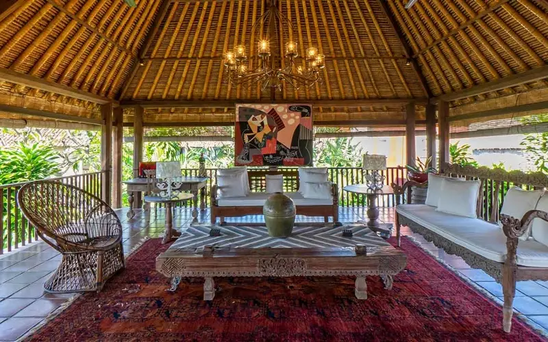 Villa Angsa, Sanur, Bali — spacious traditional living room with high thatched roof chandelier and comfortable seating | The Luxury Bali