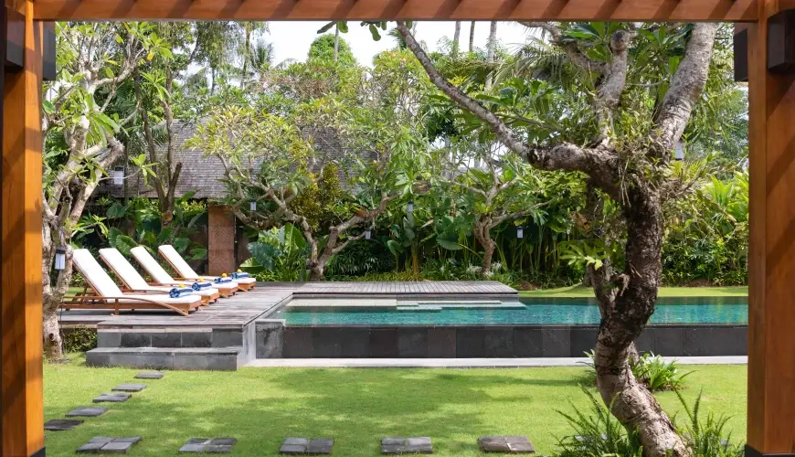 Villa Bangkuang, Canggu, Bali — relaxing balinese garden with a pool and lounge chairs | The Luxury Bali