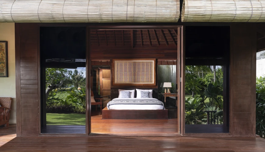 Villa Bangkuang, Canggu, Bali — traditional wooden bedroom with an open air design and garden views | The Luxury Bali