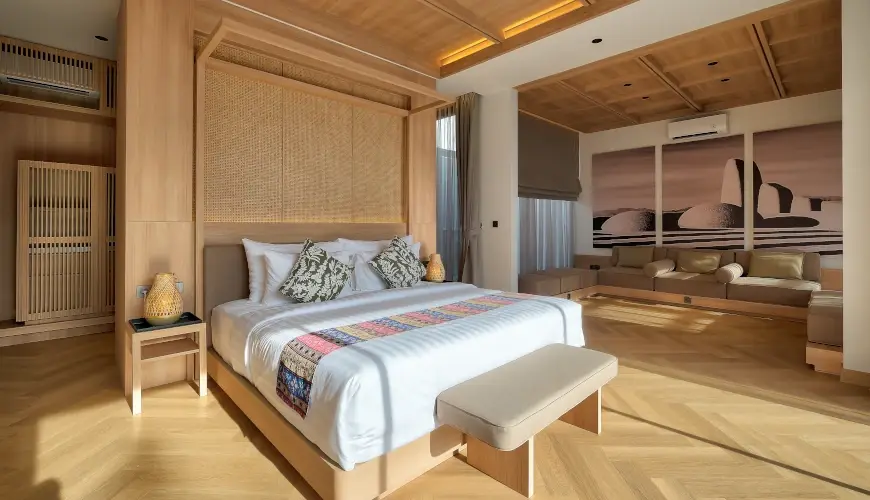 Villa Brandon, Jimbaran, Bali — luxury master bedroom with light wood accents and modern art | The Luxury Bali