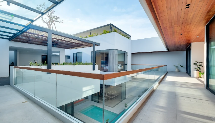 Villa Brandon, Jimbaran, Bali — modern villa balcony with glass railing overlooking the pool | The Luxury Bali