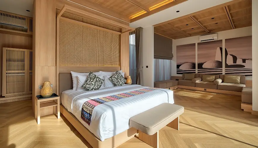 Villa Brandon, Jimbaran, Bali — stylish master suite features a comfortable lounge and striking wall accents | The Luxury Bali