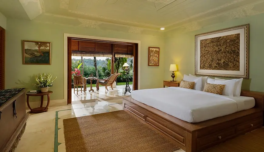 Villa Inka, Ubud, Bali — serene villa bedroom with a comfortable king size bed featuring traditional furniture and beautiful outdoor views | The Luxury Bali