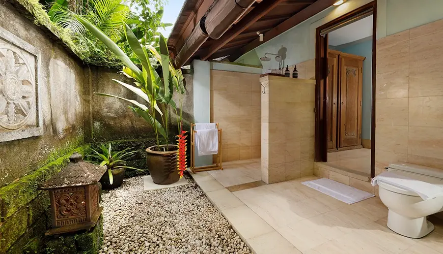 Villa Inka, Ubud, Bali — stunning outdoor villa bathroom featuring a shower area lush tropical plants and a pebble garden | The Luxury Bali