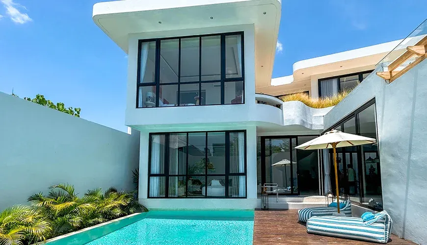 Villa Kalem Canggu, Canggu, Bali — beautiful outdoor pool area with lounge chairs and umbrella | The Luxury Bali