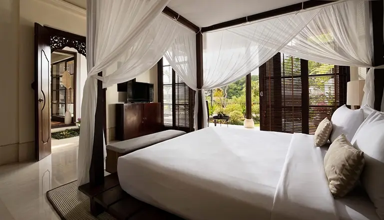 Villa Ken, Jimbaran, Bali — bedroom with canopy bed offering views of private balcony | The Luxury Bali