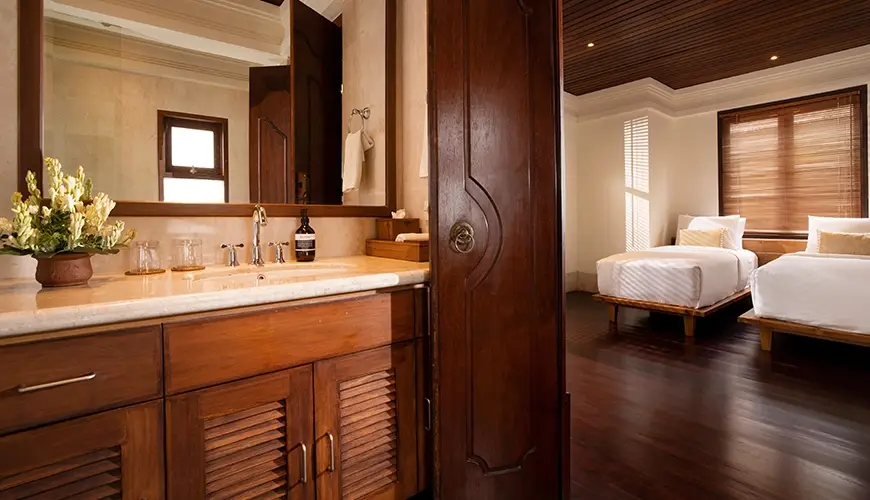 Villa Ken, Jimbaran, Bali — luxurious and well lit private villa bathroom vanity with spacious countertop and direct access to bedroom | The Luxury Bali