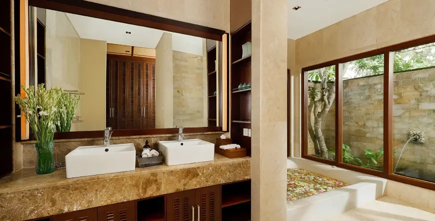 Villa Nagasutra, Uluwatu, Bali — luxurious master bathroom dual sinks flower bath | The Luxury Bali