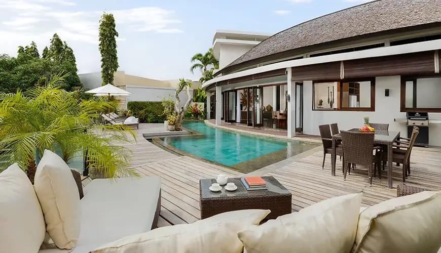 Villa Oshra, Canggu, Bali — luxurious tropical villa with a beautiful private swimming pool surrounded by a wooden deck | The Luxury Bali