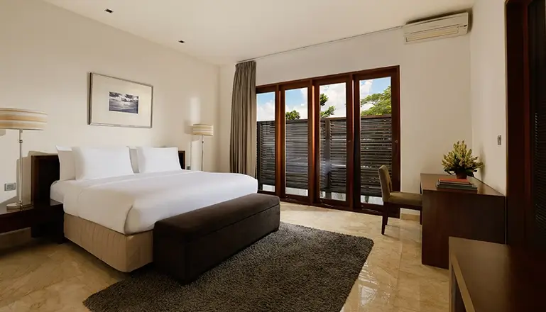 Villa Oshra, Canggu, Bali — serene villa bedroom featuring bed desk and outdoor views | The Luxury Bali