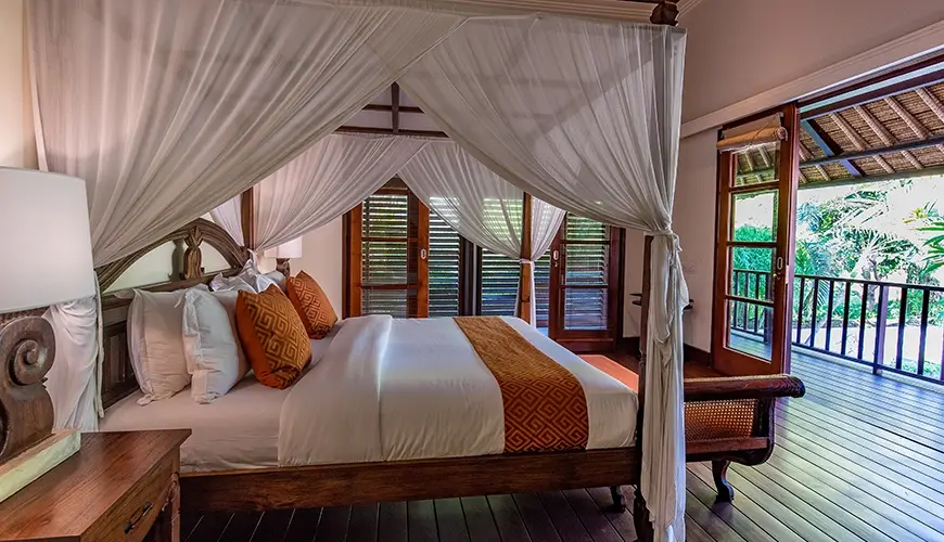 Villa Senada, Jimbaran, Bali — spacious master bedroom with canopy bed and private balcony access | The Luxury Bali
