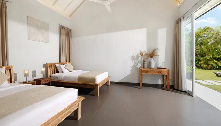 Villa Swarna, Seminyak, Bali — spacious bedroom two beds outdoor garden tropical plants view | The Luxury Bali