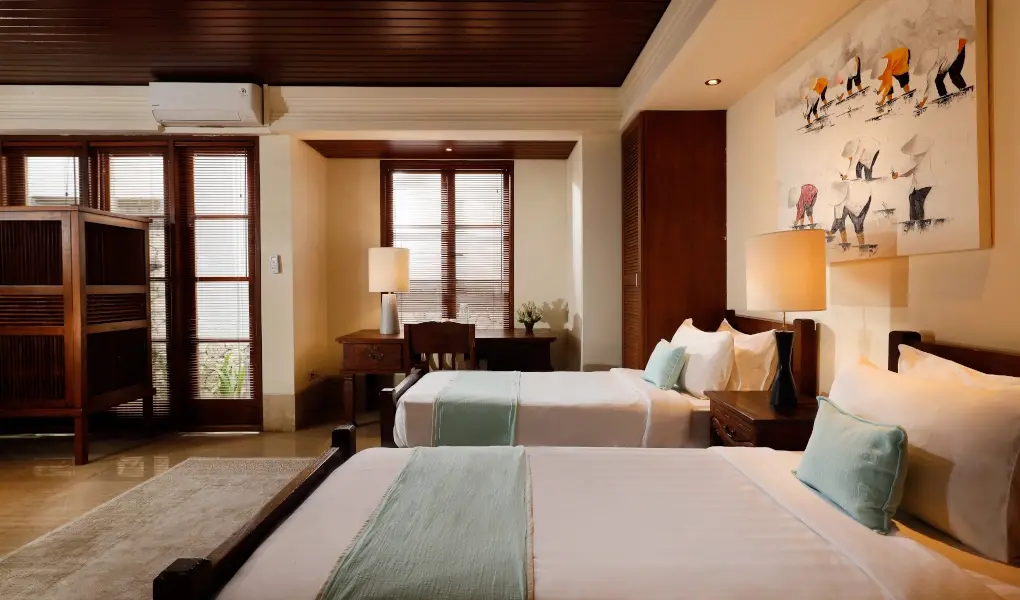 Villa The Seven, Jimbaran, Bali — bedroom with twin beds a desk and sliding glass doors | The Luxury Bali