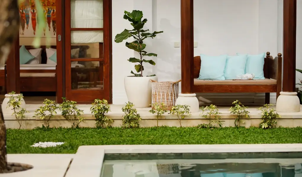 Villa The Seven, Jimbaran, Bali — outdoor lounge area by the pool with a daybed | The Luxury Bali