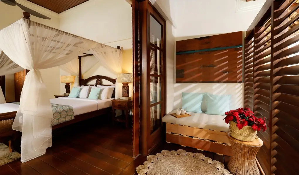 Villa The Seven, Jimbaran, Bali — tropical bedroom with a canopy bed and a daybed on balcony | The Luxury Bali