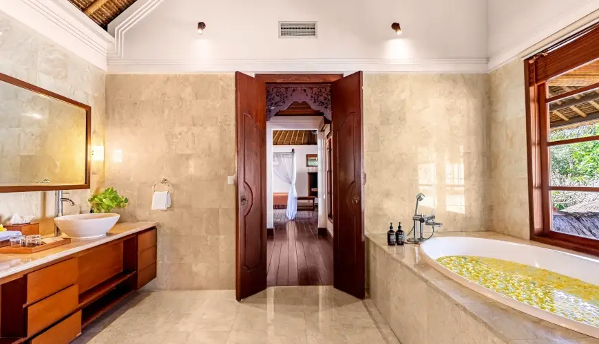 Villa Umarya, Jimbaran, Bali — modern balinese bathroom with beautiful carved wood | The Luxury Bali
