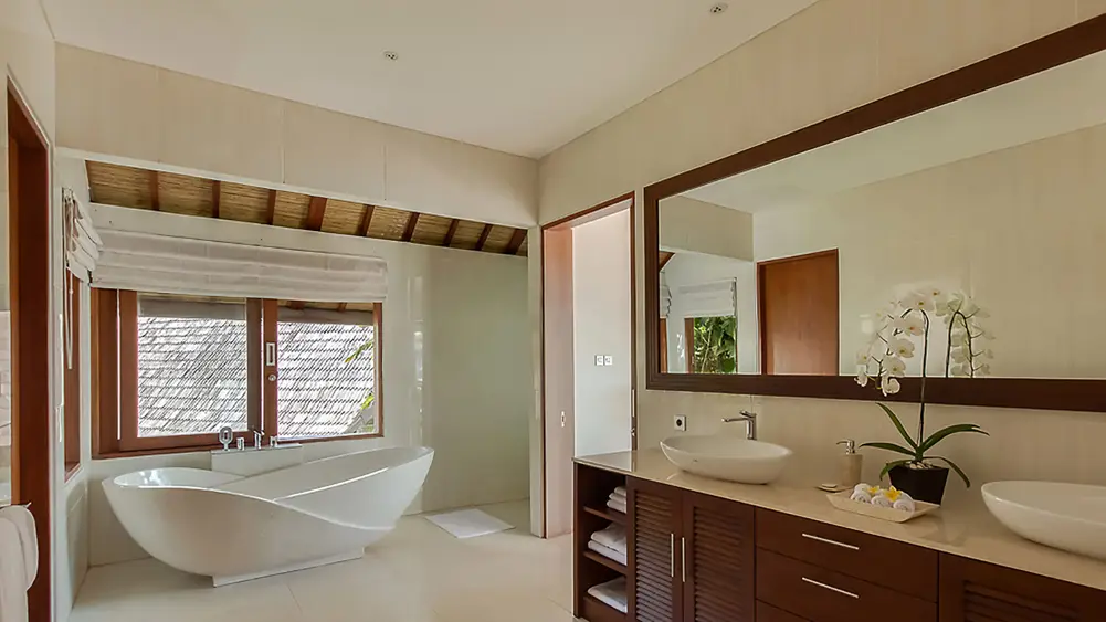 Villa Tirta Nila, Candidasa, Bali — luxurious master bedroom ensuite with freestanding bathtub | The Luxury Bali