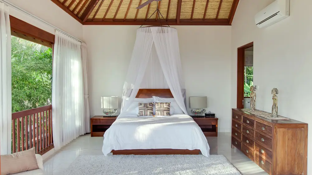 Villa Tirta Nila, Candidasa, Bali — relaxing upstairs guest bedroom | The Luxury Bali