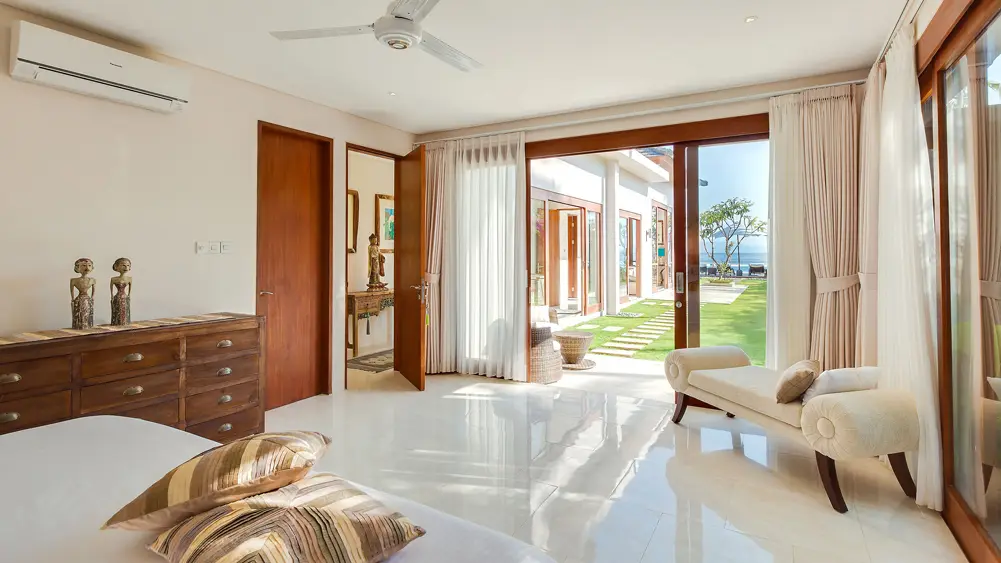 Villa Tirta Nila, Candidasa, Bali — breezy guest bedroom by the garden lawn | The Luxury Bali