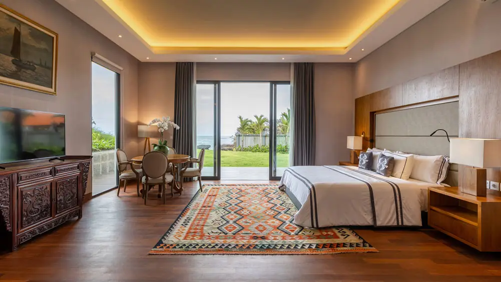 Tirtha Bayu Estate - Villa I, Seseh, Bali — deluxe suite with seating area and garden access | The Luxury Bali