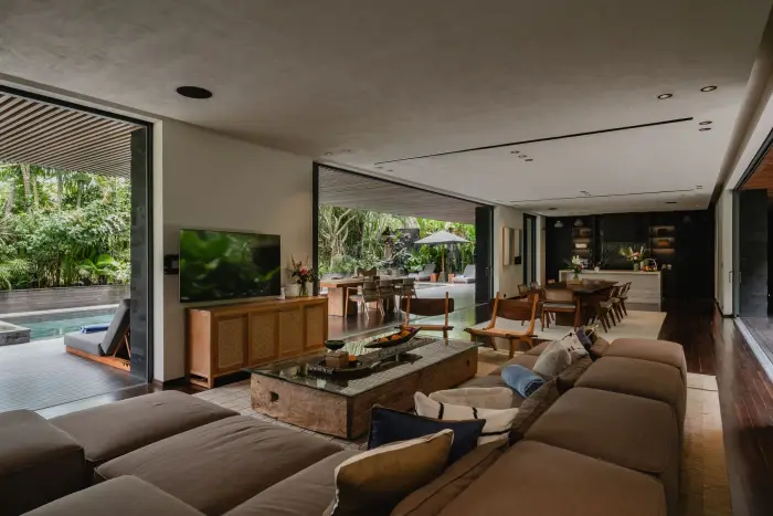 The living room at Ocean Palm Estate, open to the pool